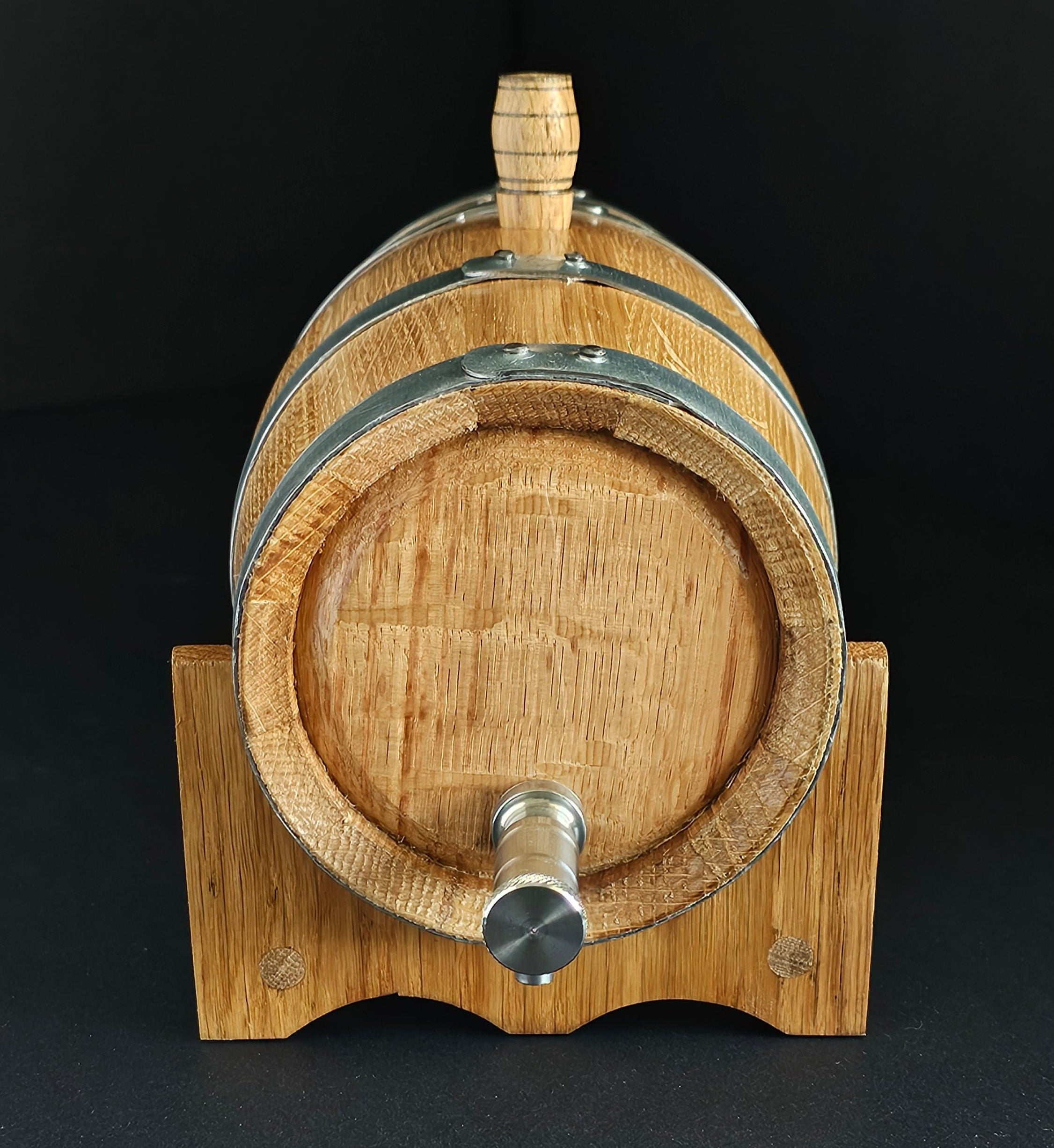 Wooden oak miniature barrel with steel tap and hoops. Front view. Black background. Handcrafted in Cork, Ireland by O'Mahony Craft Cooperage.