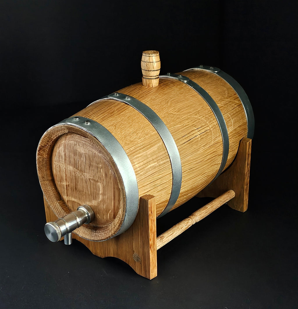 Wooden oak miniature barrel with steel tap and hoops. Angled so full cask is visible from front to back. Black background. Handcrafted in Cork, Ireland by O'Mahony Craft Cooperage.